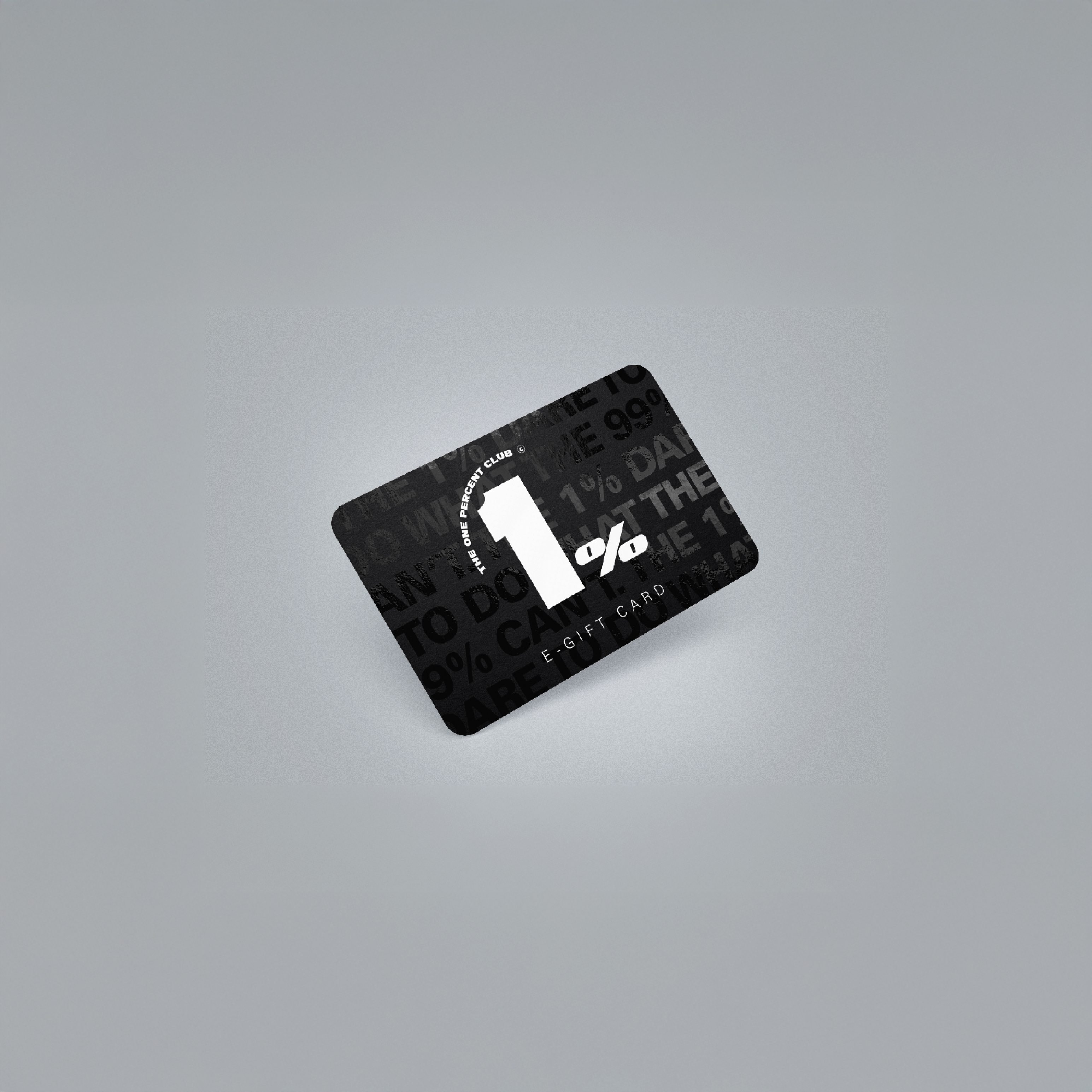 An angled 3d picture of a black gift card on a grey background. The text on the gift card reads: THE ONE PERCENT CLUB. 1%. E-GIFT CARD. There is also a background pattern with faint, partially visible text, which includes phrases like: "THE 1% DARE TO DO WHAT THE 99% CAN'T."